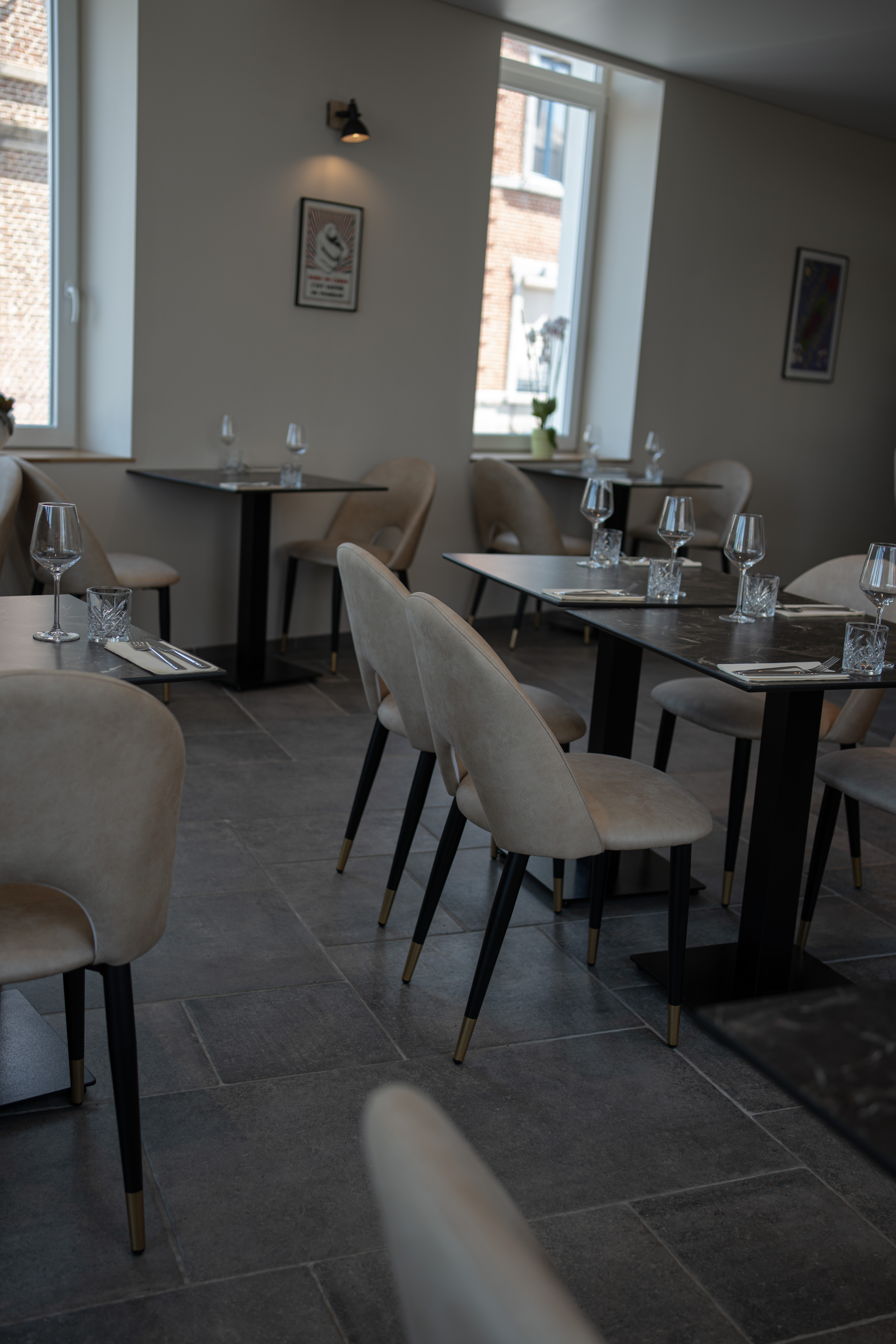 Salle du bar avec tables dress&eacute;es et affiches au mur