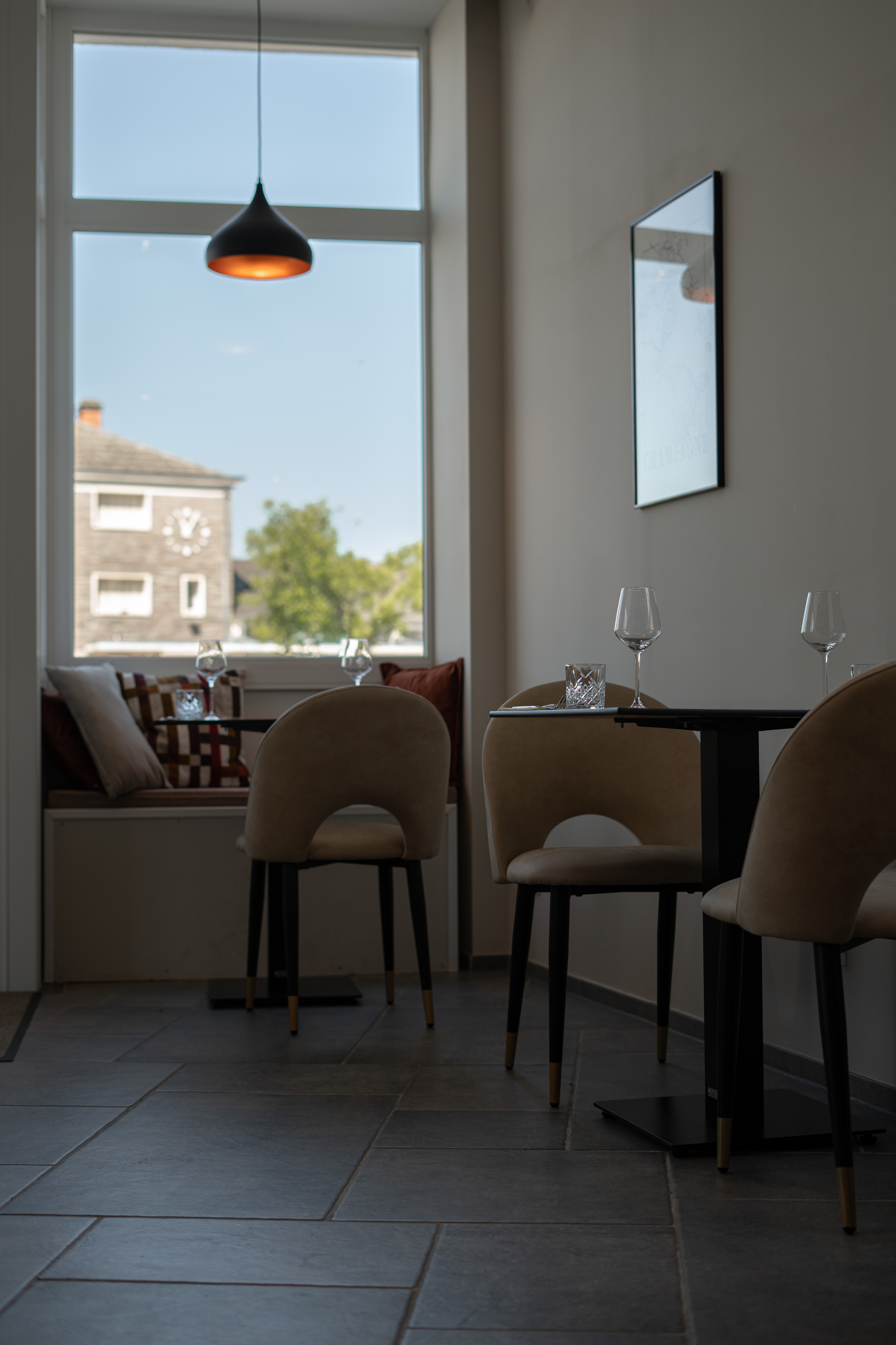 Table pr&egrave;s de la fen&ecirc;tre avec banquette et coussins